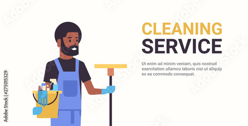 man janitor holding bucket with tools and mop cleaning service concept smiling african american male cleaner portrait horizontal copy space flat
