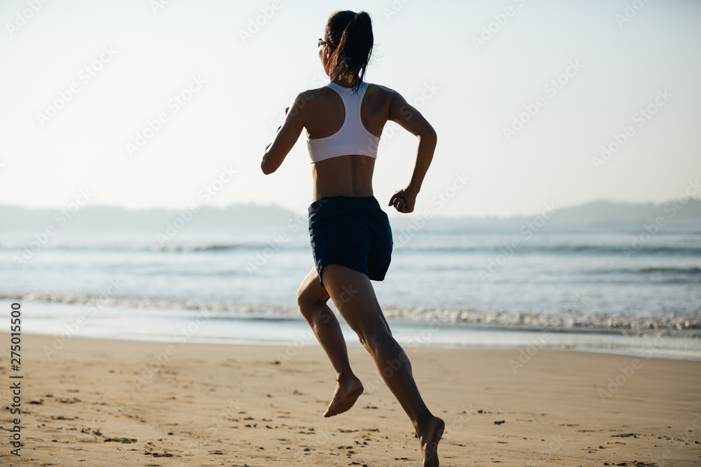 Young fitness woman running at sunrise beach Young fitness woman running at sunrise beach