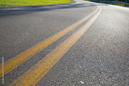 Wallpaper Mural Asphalt Road With Double Yellow Lines And Green Grass To The Side. Selective Focus Road Travel And Transportation Concept. Torontodigital.ca