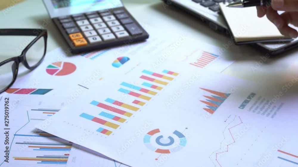 Businesswoman working on Desk office with marketing graph statistics analysis Businesswoman working on Desk office with marketing graph statistics analysis