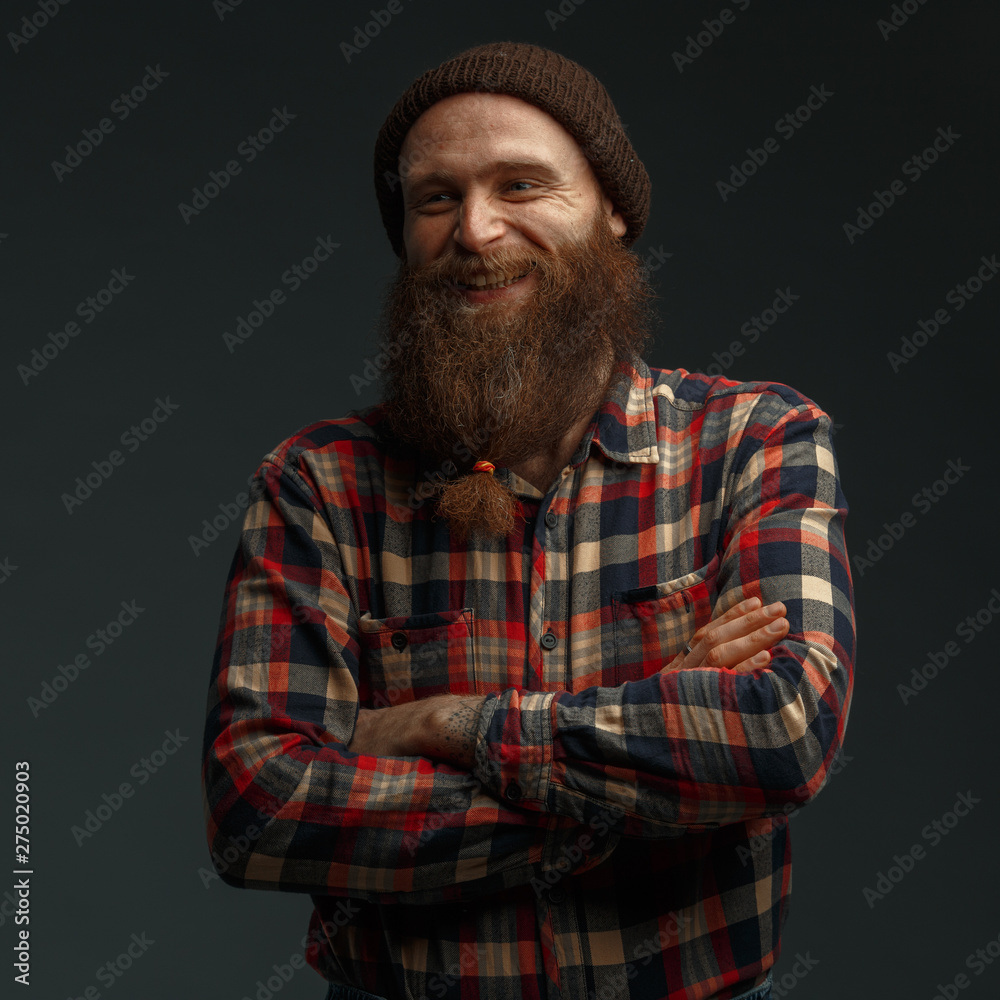 Brutal man with a red beard and tattoos on his hands. Barber in retro style. Brutal man with a red beard and tattoos on his hands. Barber in retro style.