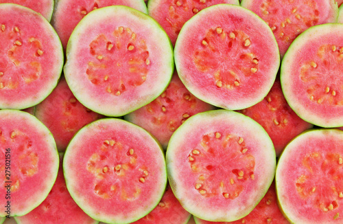 Canvas Print Slices of pink guava as background
