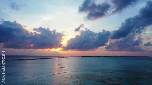 beautiful sunrise at Bali, Indonesia, Dramatic Sky Scenery Over Tropical Sea With coral reef and Reflection In The Water, aerial drone slow parallax shot photo