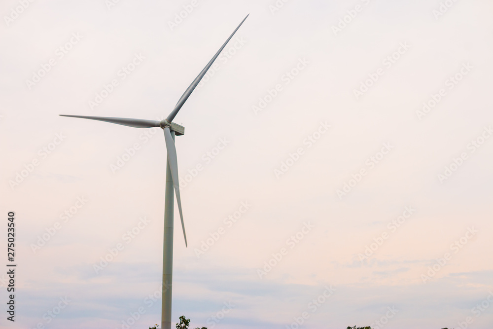 Wind turbine farm power generator in beautiful nature landscape for production of renewable green energy is friendly industry to environment.