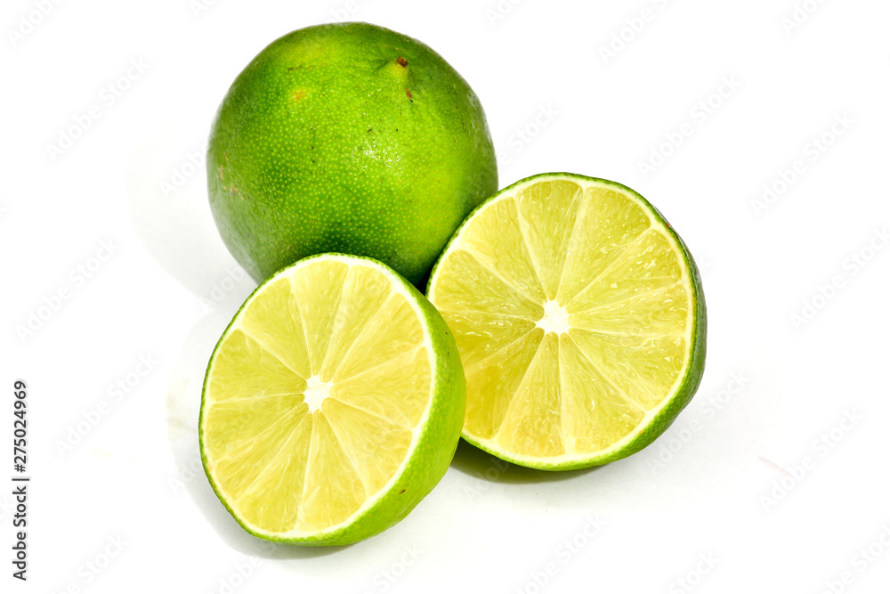 Fresh green lime cut in half isolated on white background. Fresh green lime cut in half isolated on white background.