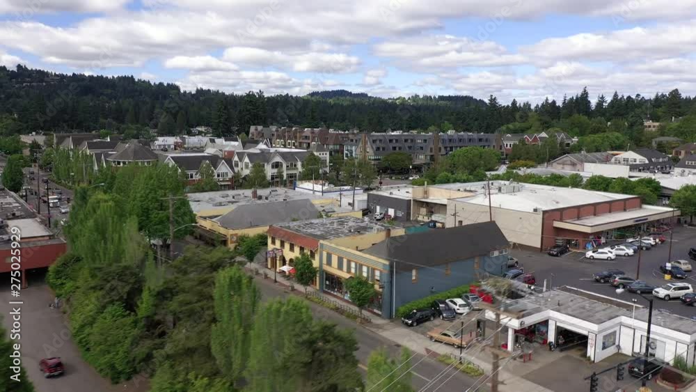 Aerial trucking shot showing train tracks and businesses in lake oswego.