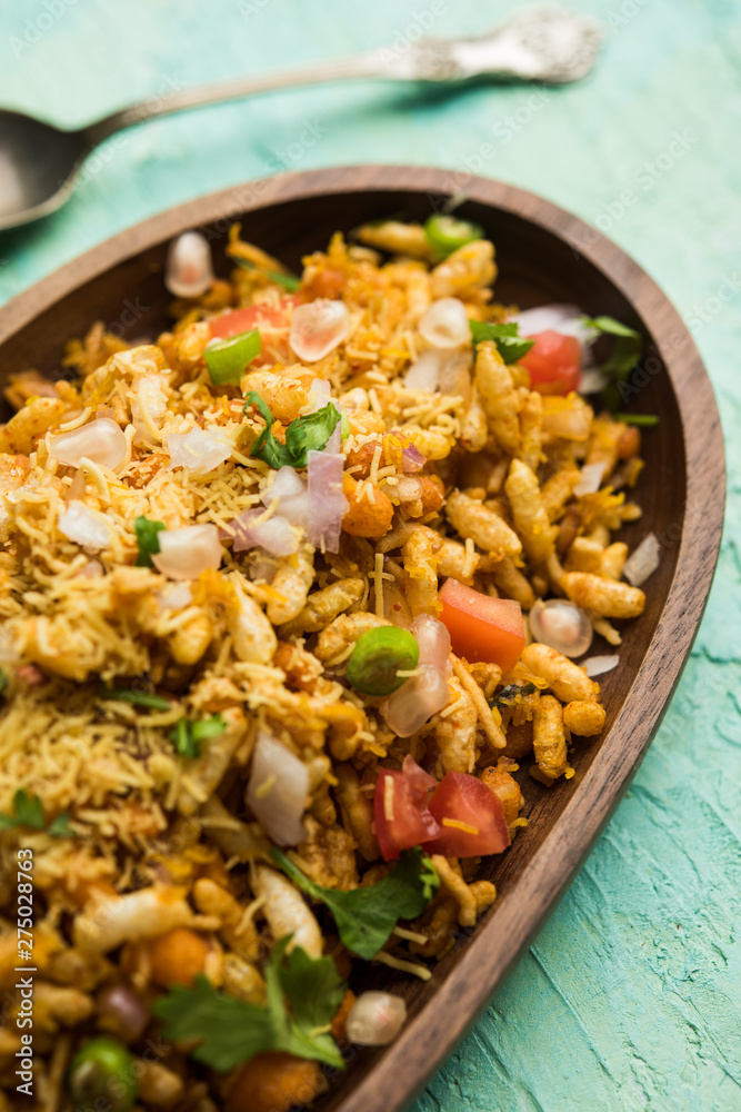Bhelpuri Chaat/chat is a road side tasty food from India, served in a bowl or plate. selective focus Bhelpuri Chaat/chat is a road side tasty food from India, served in a bowl or plate. selective focus