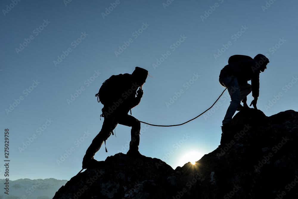 concept of professional two climbers crossing the cliffs - obrazy, fototapety, plakaty 