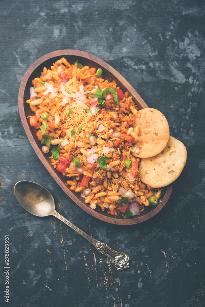 Bhelpuri Chaat/chat is a road side tasty food from India, served in a bowl or plate. selective focus Bhelpuri Chaat/chat is a road side tasty food from India, served in a bowl or plate. selective focus