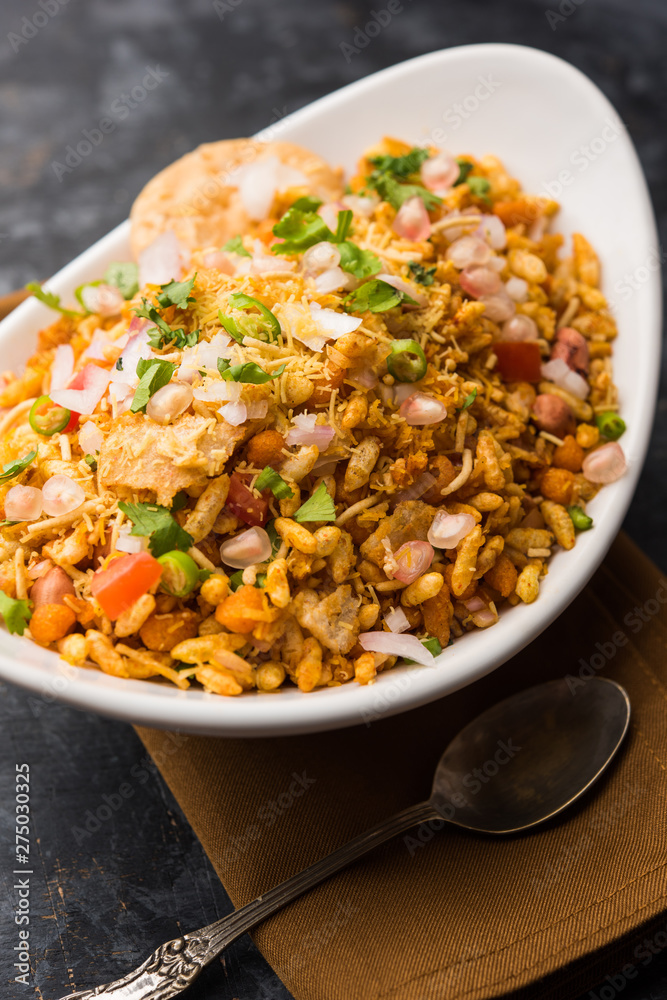 Bhelpuri Chaat/chat is a road side tasty food from India, served in a bowl or plate. selective focus Bhelpuri Chaat/chat is a road side tasty food from India, served in a bowl or plate. selective focus