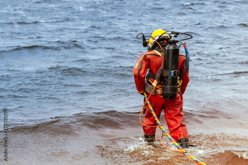 Professional diver enters the water to produce deep-sea works.