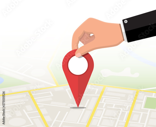 Location pin in hand and map. City map with houses, parks, streets and roads. City aerial view. GPS, navigation and cartography. Vector illustration in flat style