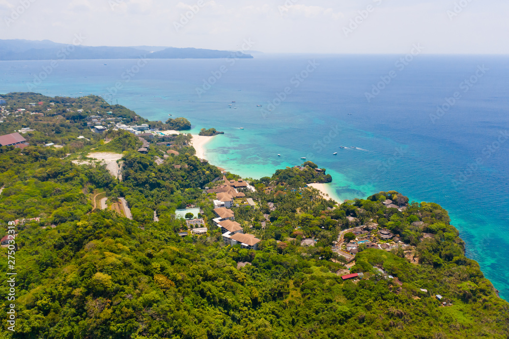 Boracay island, view from above. Rocky coast with rainforest. Seascape with green island.