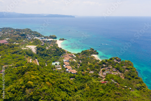 Boracay island, view from above. Rocky coast with rainforest. Seascape with green island.