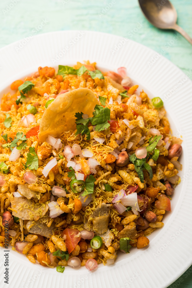 Bhelpuri Chaat/chat is a road side tasty food from India, served in a bowl or plate. selective focus Bhelpuri Chaat/chat is a road side tasty food from India, served in a bowl or plate. selective focus