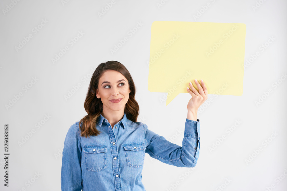 Young woman holding speech bubble with copy space Young woman holding speech bubble with copy space