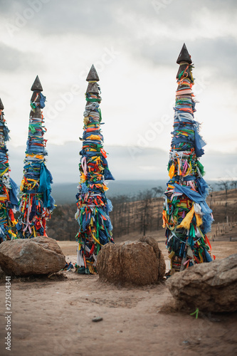 ritual wooden poles tied with multi-colored pieces of cloth