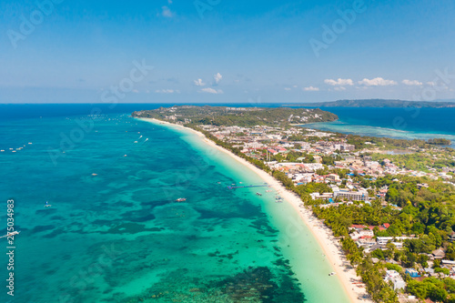 Fototapeta Naklejka Na Ścianę i Meble -  The coast of the island of Boracay. White beach and clear sea. Seascape with a beautiful coast in sunny weather. Residential neighborhoods and hotels on the island of Boracay, Philippines, view from
