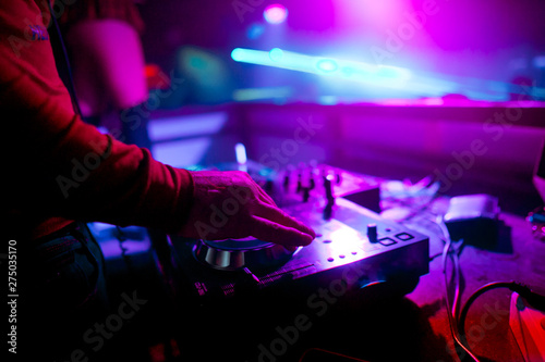 Dj mixing outdoor at beach party festival with crowd of people in background - Summer nightlife view of disco club outside - Soft focus on hand - Fun ,youth,entertainment and fest concept © Семен Саливанчук