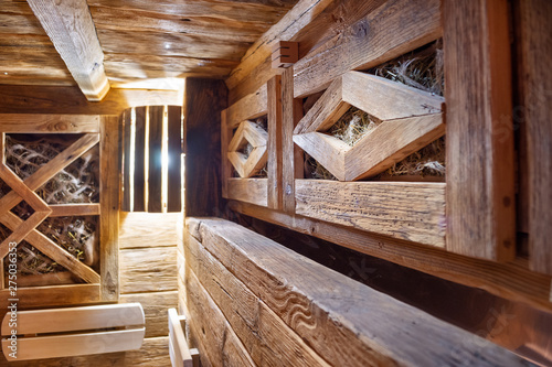 Handmade bath in the spa complex. The bath is trimmed with planks and hay.