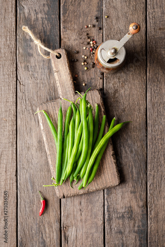 Overhead shot of fresh green bean with pepper mill