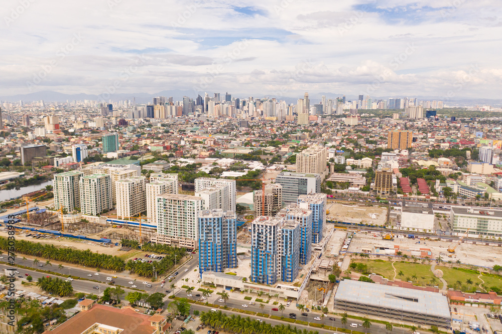Construction of high modern houses in Manila. The city of Manila, the capital of the Philippines. Modern metropolis in the morning, top view. New buildings in the city.