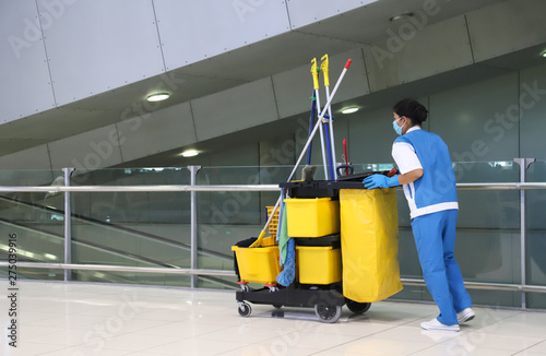 Closeup of woman cleaning worker doing her work with janitorial,  cleaning equipment and tools for floor cleaning.