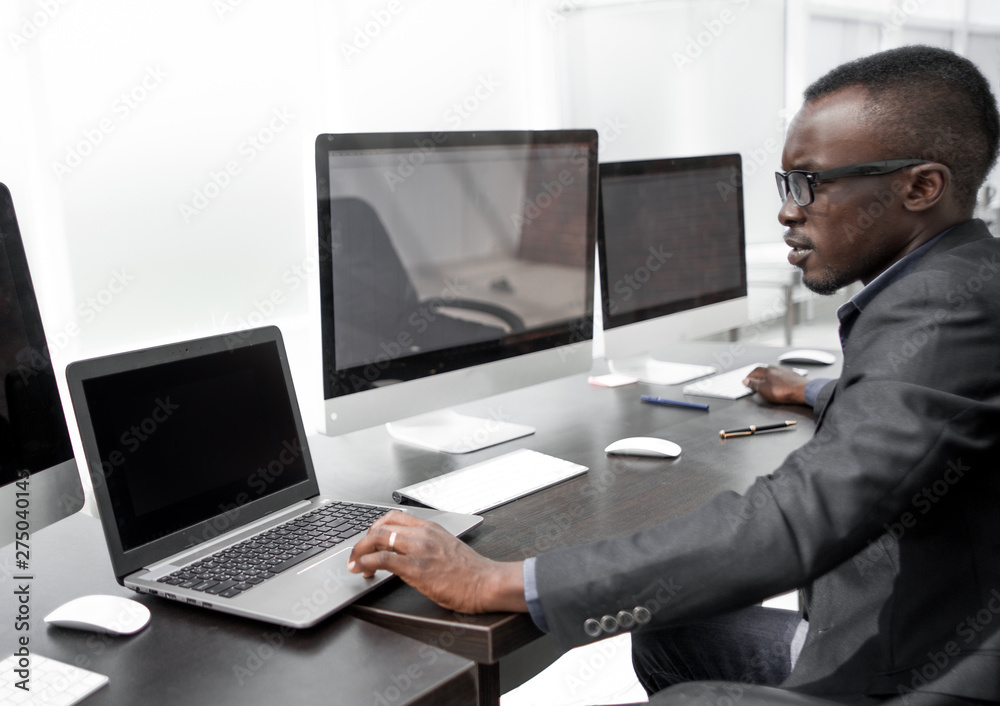 young businessman working at a computer in the computer room young businessman working at a computer in the computer room
