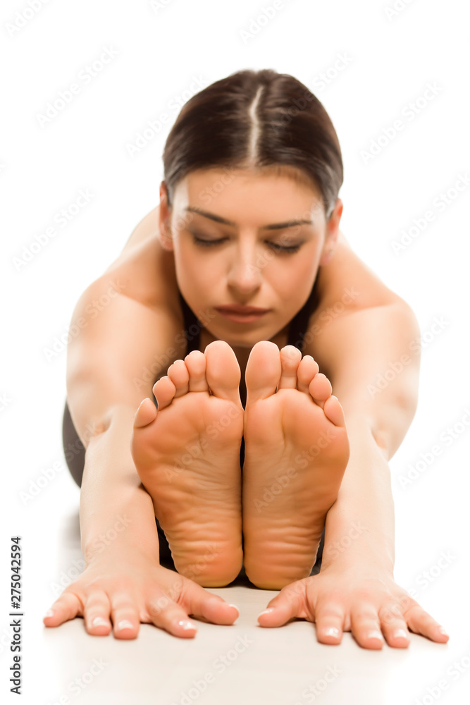 Obraz premium Yoga flexible woman doing yoga seated forward bend pose isolated on white background