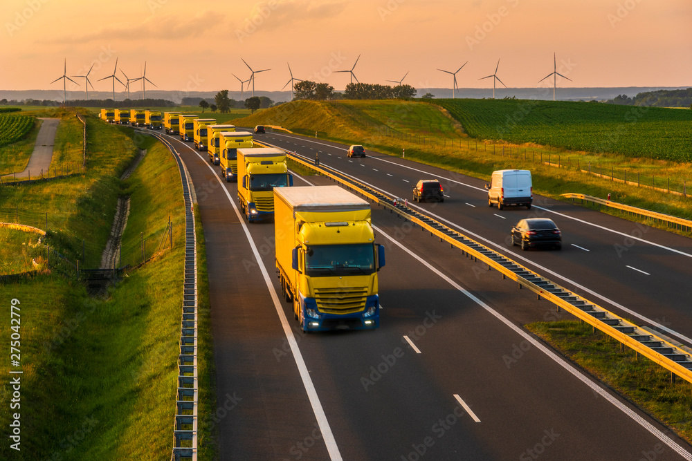 intensive highway traffic at sunset - column of trucks on the motorway in Poland - obrazy, fototapety, plakaty 