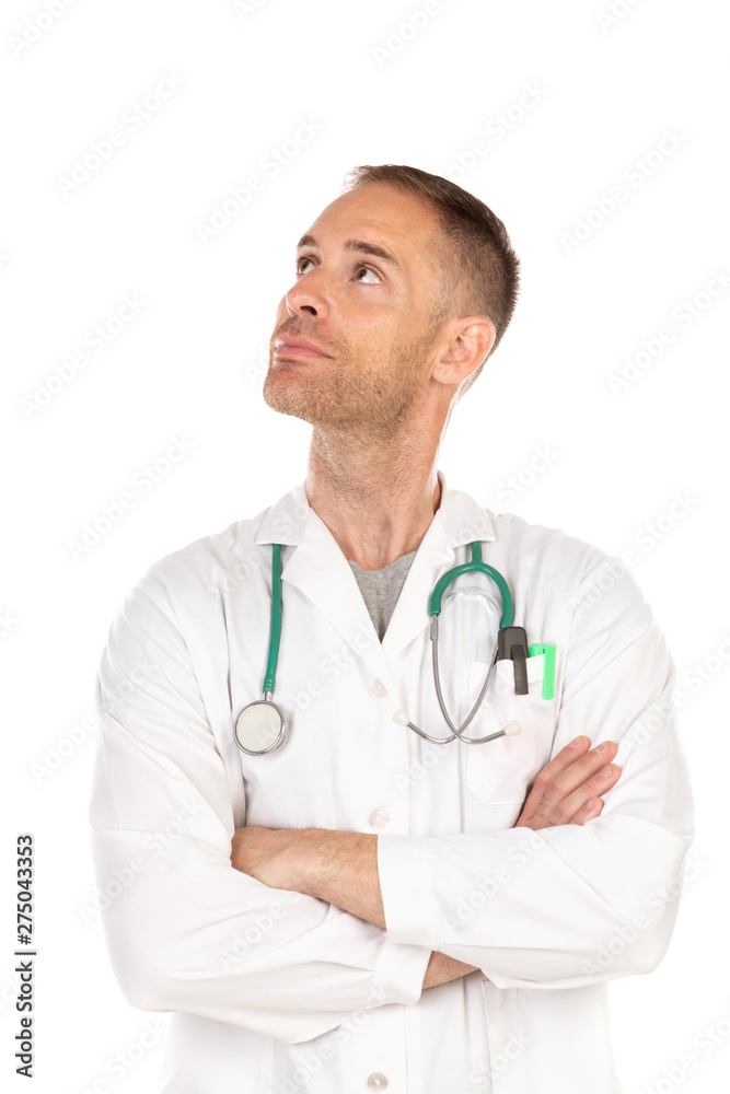 Pensive young doctor wearing a white gown