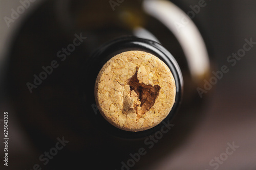 wine bottle with cork on dark background close up view