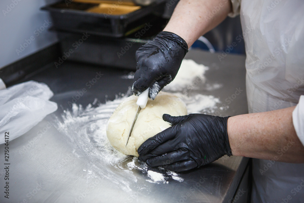 The process of making dumplings, dumplings close-up. The rolling test, the unfolding of beef, dumpling making gloved hands.