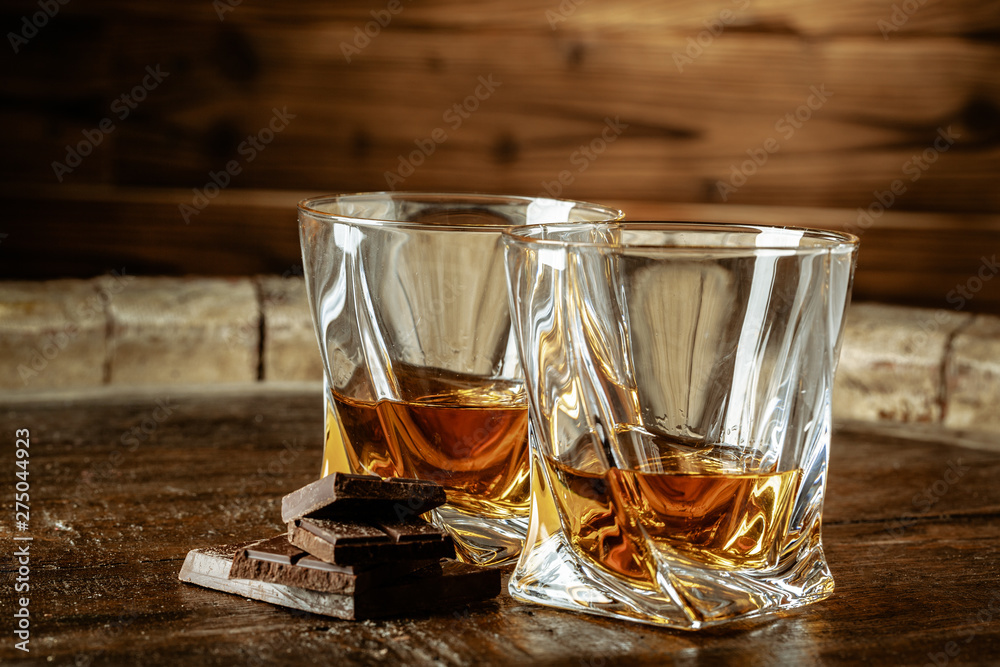 Two glasses of bourbon or scotch, or brandy and pieces of dark chocolate Two glasses of bourbon or scotch, or brandy and pieces of dark chocolate
