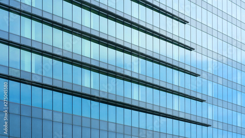 Glass windows of high rise commercial skyscraper building   for business concept background .