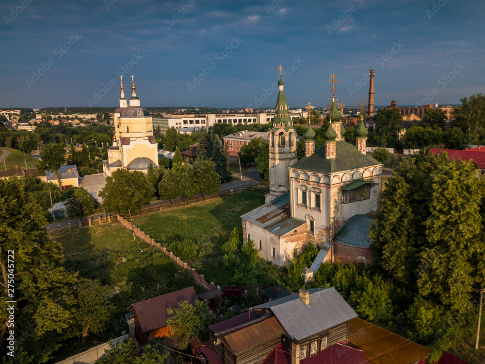 Aerial view of the ancient Orthodox Christian monastery, located among the houses and nature in the city of Serpukhov. Early summer morning. Moscow region