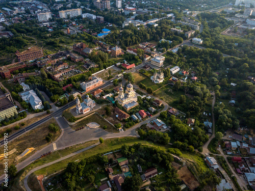 Aerial view of the ancient Orthodox Christian monastery  located among the houses and nature in the city of Serpukhov. Early summer morning. Moscow region