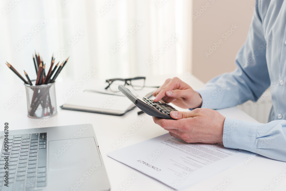 Fototapeta premium Office desktop with laptop and a business man