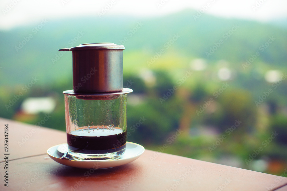 Drip Black Coffee vietnamese style on balcony with alpine background