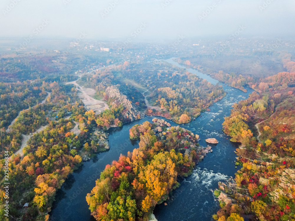 aerial drone view of colorful forest, blue river and rocks. beautiful autumn landscape