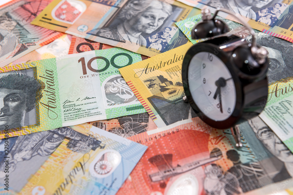 Clock with alarm at australian dollars close up Clock with alarm at australian dollars close up