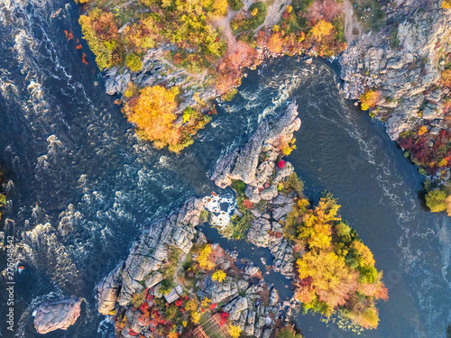 colorful forest, blue river and rocks. natural beautiful autumn landscape (background). drone shot, bird's-eye, aerial view