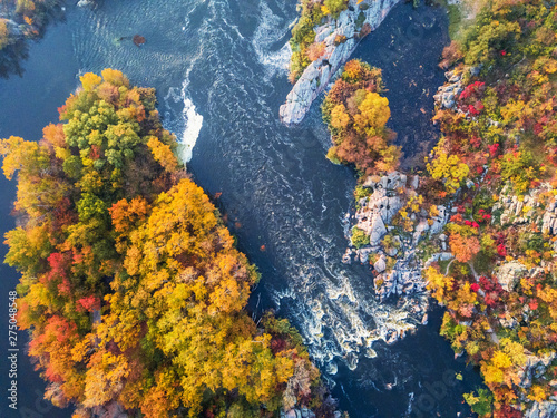 colorful forest, blue river and rocks. natural beautiful autumn landscape (background). drone shot, bird's-eye, aerial view