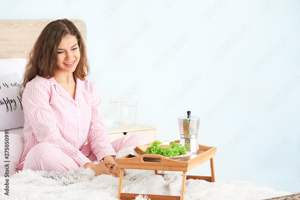 Beautiful young woman having breakfast in bed Beautiful young woman having breakfast in bed