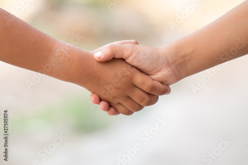 Children show cooperation sign by holding hands or shake hands, Cooperation concept image design