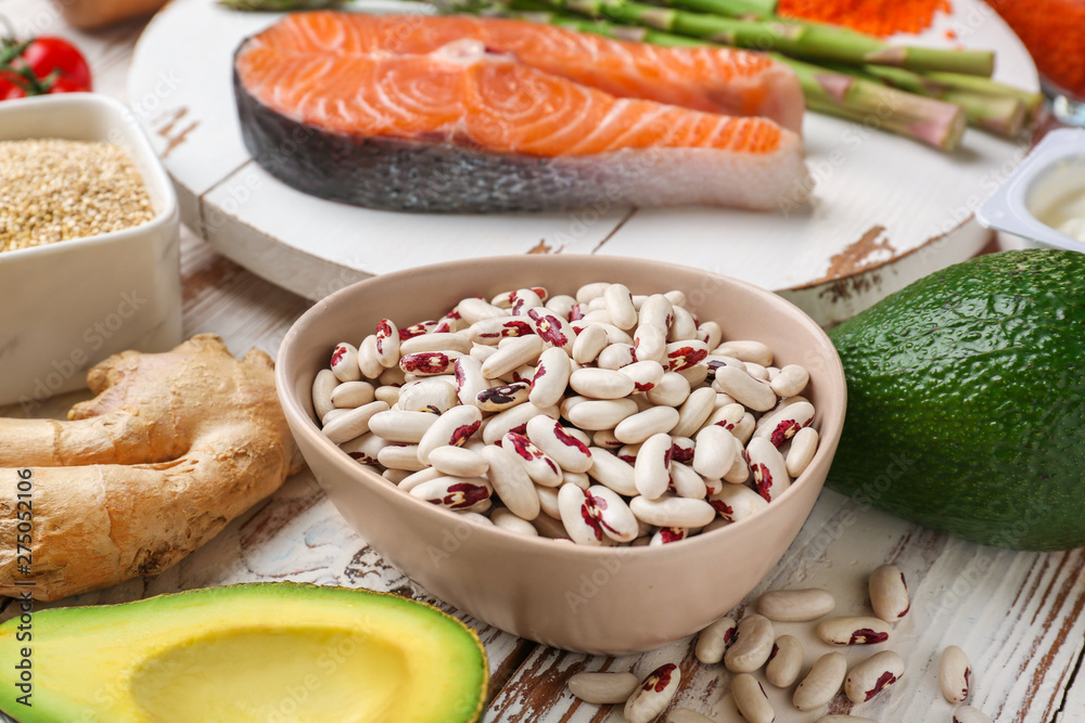 Different healthy food on white wooden table