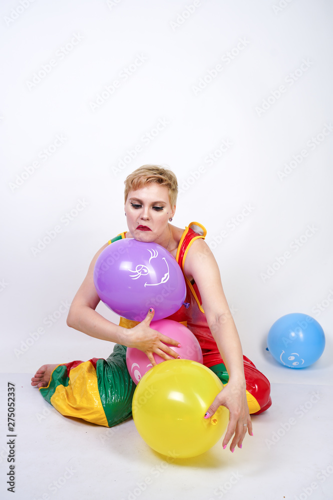 funny happy clown girl with colorful air ballons on white studio background funny happy clown girl with colorful air ballons on white studio background