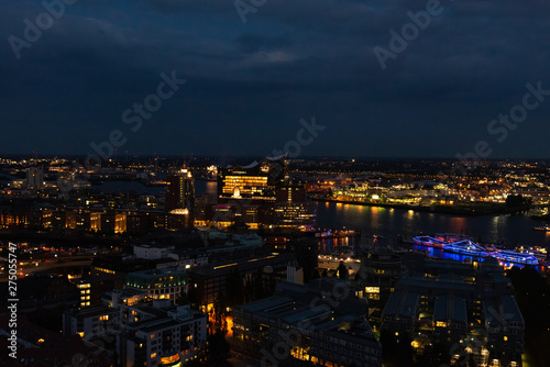Aerial view of Hamburg  Germany in the evening with fireworks next to the new Elbphilharmony  Elphi  and illuminated boats