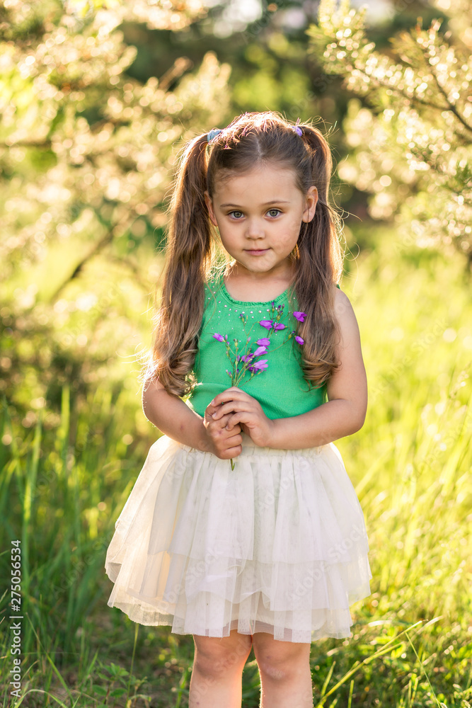 little girl with flowers bells on nature in summer little girl with flowers bells on nature in summer