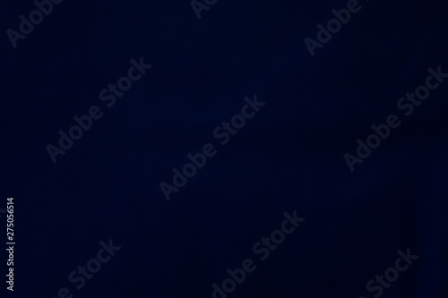 Velvet matte texture, dark blue corduroy fabric background close-up.